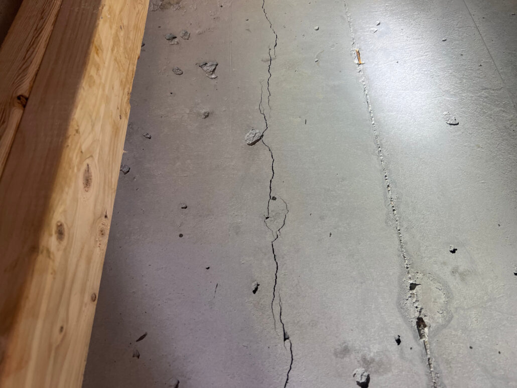 Concrete wall in basement with a shrinkage crack