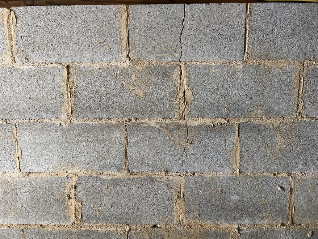 Concrete block wall with thin vertical crack