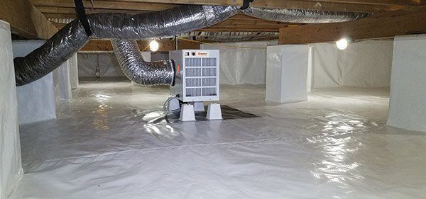 A pristine encapsulated crawlspace with a dehumidifier in the middle.