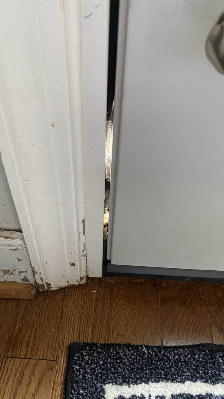 Poorly maintained door illustrating drafty doors need to be part of your winter maintenance plan