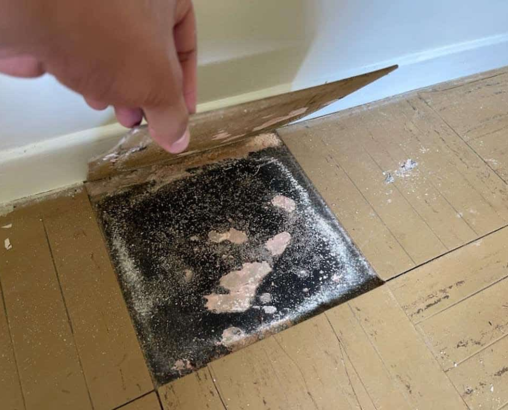 Tiles with black sealant likely contain asbestos