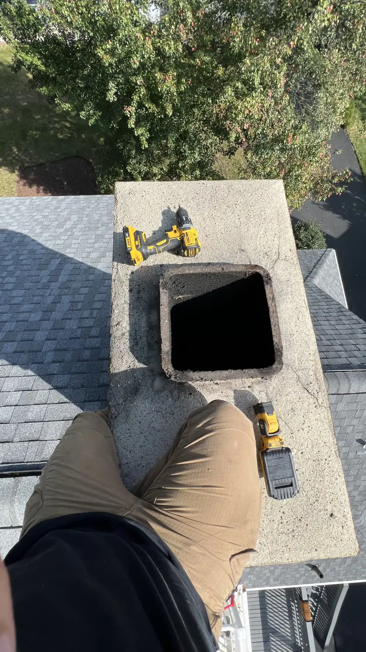 Home inspector performs chimney inspection.