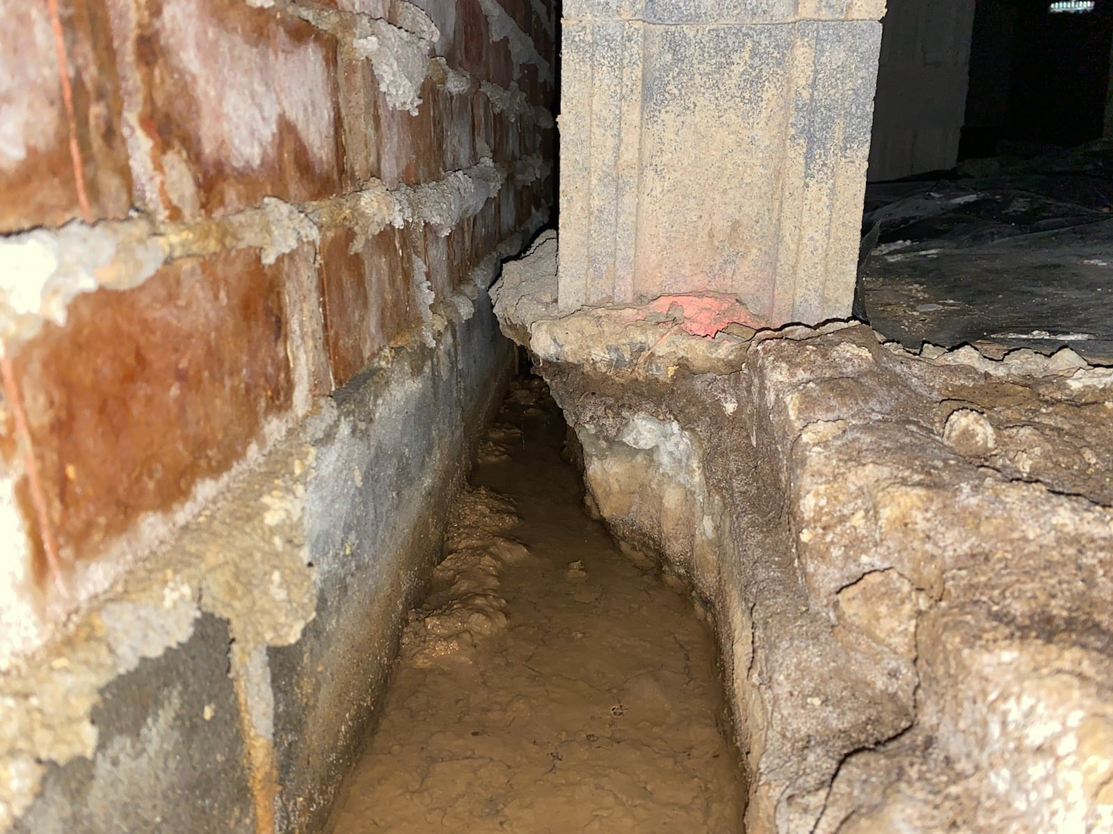 Water running through a crawlspace illustrates the importance of a home inspection.