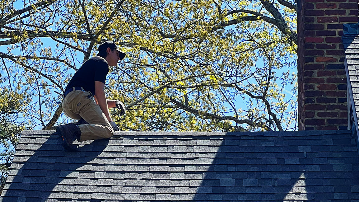 Home inspector on roof demonstrates how important it is to inspect the roof.