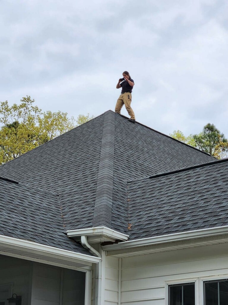 Home inspector takes photo of roof demonstrating a thorough roof inspection